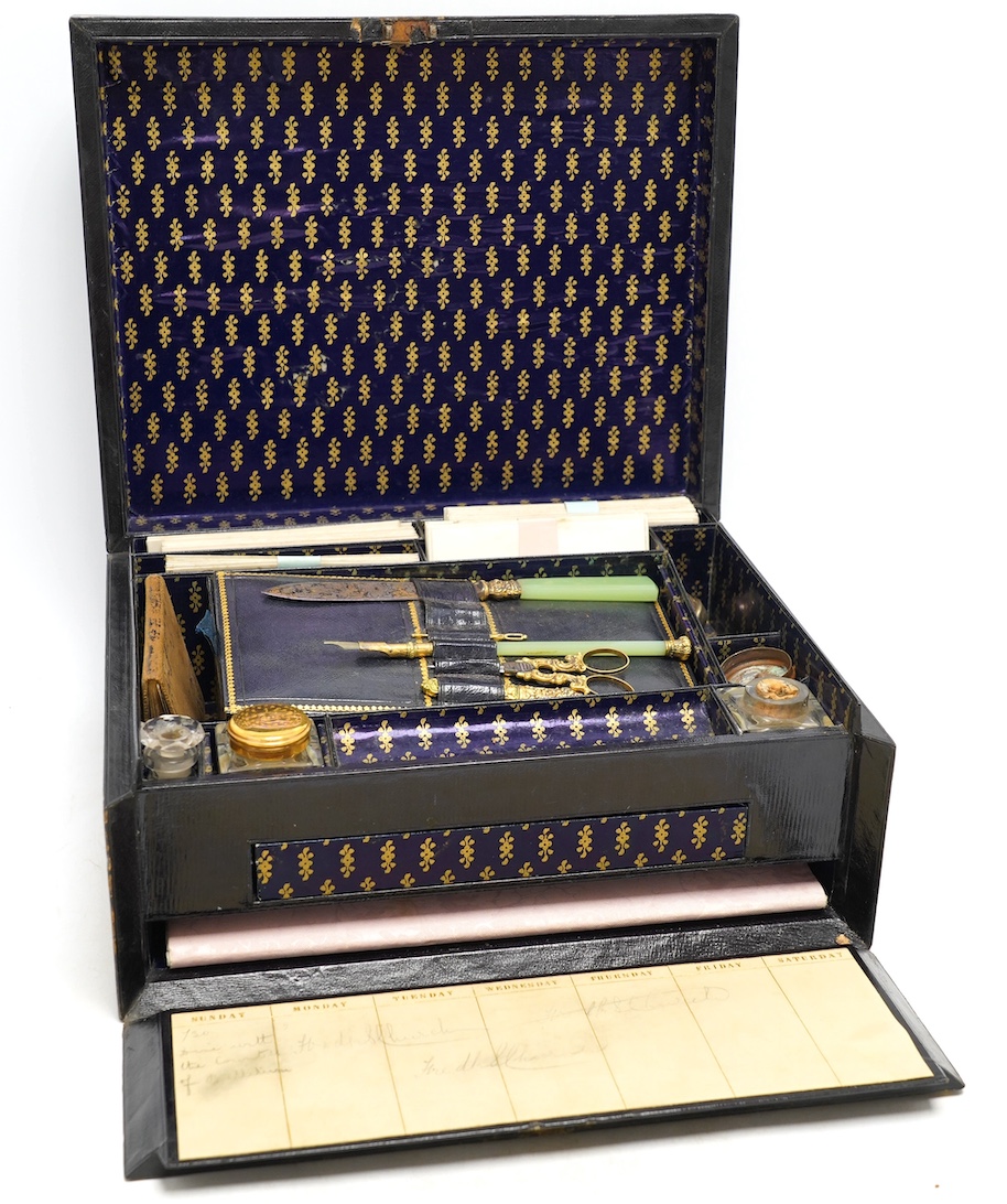 A Victorian black Moroccan leather paper lined and fitted writing box, with some implements, 30cm x 12.5cm. Condition - fair